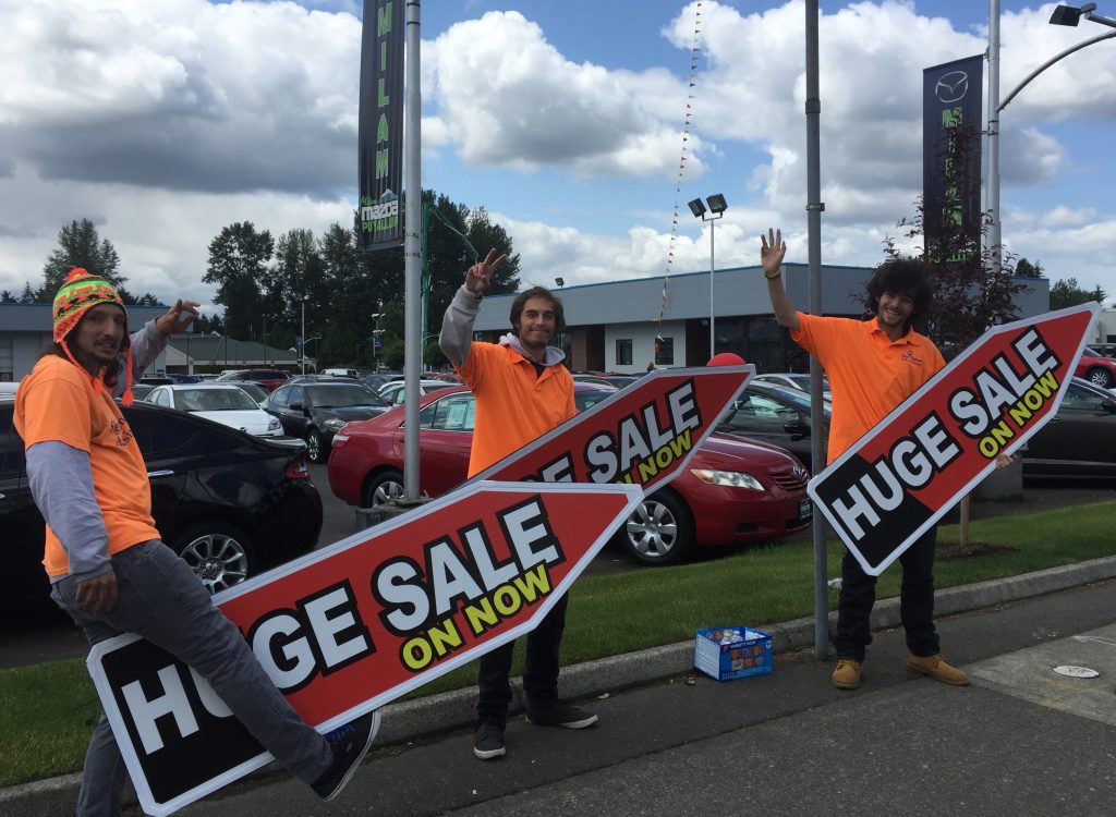 Sign Spinners in Seattle Promote Puyallup Car Sale for Memorial Day